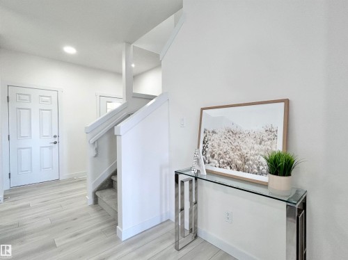 Stairs with wood finished floors and recessed lighting - 19634 29 Avenue, Edmonton, AB - Indoor Photo Showing Other Room
