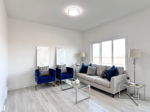 Living area featuring light wood-style flooring and baseboards - 19634 29 Avenue, Edmonton, AB - Indoor Photo Showing Living Room