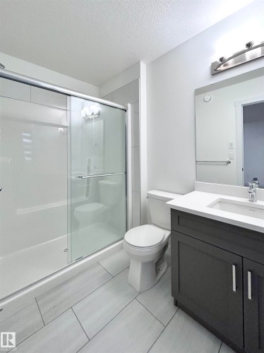 Full bathroom featuring vanity, a shower stall, and a textured ceiling - 19634 29 Avenue, Edmonton, AB - Indoor Photo Showing Bathroom