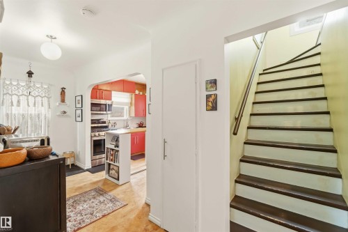 Interior staircase with painted treads and a metal handrail - 6036 106 Street, Edmonton, AB - Indoor Photo Showing Other Room