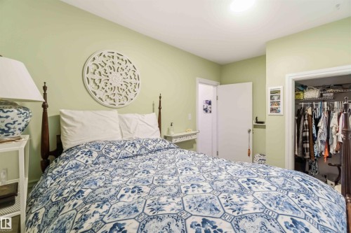 Bedroom featuring light green wall paint and white trim - 6036 106 Street, Edmonton, AB - Indoor Photo Showing Bedroom