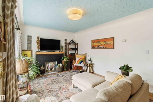 Living area featuring a textured blue ceiling and recessed lighting - 6036 106 Street, Edmonton, AB - Indoor Photo Showing Living Room With Fireplace