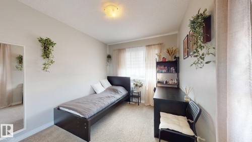 This room features light-colored walls and carpeting, a window with blinds and drapes, and a ceiling light fixture - 1275 Chappelle Boulevard, Edmonton, AB 