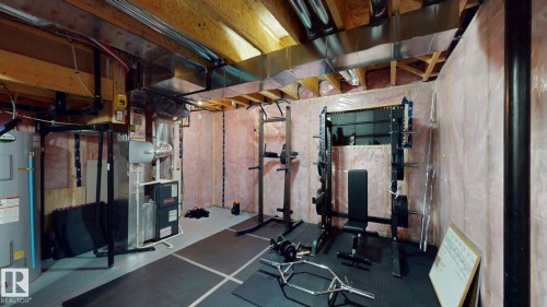 The property features an unfinished basement with exposed wooden beams, ductwork, and insulation - 1275 Chappelle Boulevard, Edmonton, AB 