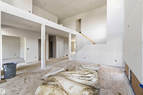 This property features an open-concept layout with high ceilings and drywall installation underway, offering a blank canvas for customization - 33 Harley Way Nw, Spruce Grove, AB - Indoor