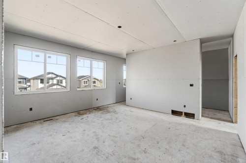 The property features an interior space currently under construction, with walls prepared for finishing - 33 Harley Way Nw, Spruce Grove, AB - Indoor Photo Showing Garage