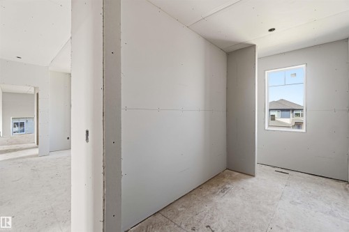 Interior view of a property under construction, featuring bare drywall walls and unfinished concrete flooring - 33 Harley Way Nw, Spruce Grove, AB - Indoor