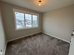 Room featuring neutral tone walls and plush gray carpeting - 