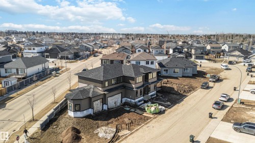 The property is a two-story home with a dark gray roof and a brown exterior - 33 Harley Way Nw, Spruce Grove, AB - Outdoor With View