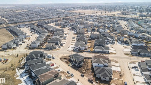 Aerial view of a residential neighbourhood featuring numerous detached properties with dark roofs - 33 Harley Way Nw, Spruce Grove, AB - Outdoor With View