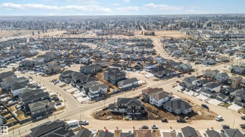 Aerial view showcasing the residential neighbourhood with numerous detached properties featuring diverse rooflines - 33 Harley Way Nw, Spruce Grove, AB - Outdoor With View
