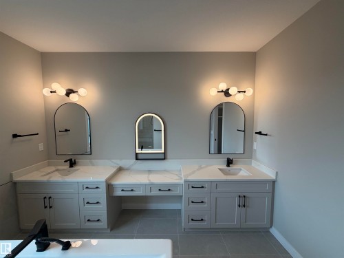 Dual vanity with light gray cabinetry, quartz countertops, and matte black hardware - 33 Harley Way, Spruce Grove, AB - Indoor Photo Showing Bathroom