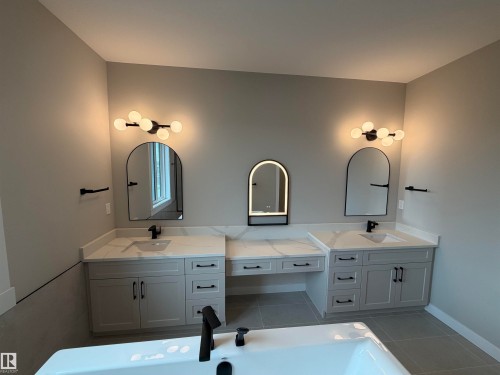 Dual vanities featuring white countertops, undermount sinks, and matte black fixtures - 33 Harley Way, Spruce Grove, AB - Indoor Photo Showing Bathroom