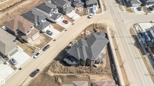 Aerial view of a residential area featuring several properties with shingled roofs and paved driveways - 33 Harley Way, Spruce Grove, AB - Other
