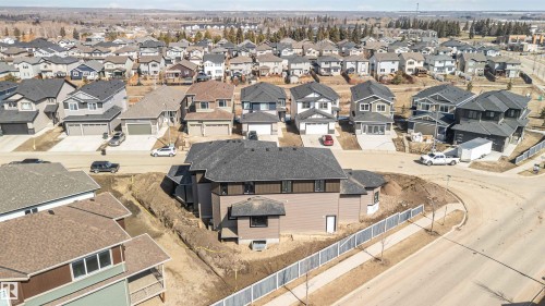 This property features a contemporary architectural style with a dark grey roof and light brown siding - 33 Harley Way, Spruce Grove, AB - Outdoor With View