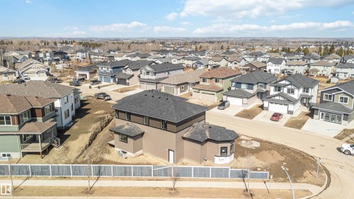 This property features a newly constructed residence with a dark shingled roof, offering a view of the surrounding residential area - 33 Harley Way, Spruce Grove, AB - Outdoor