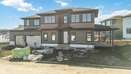 The property features a two-story design with a covered entry, an attached garage, and a covered side patio - 33 Harley Way Nw, Spruce Grove, AB - Outdoor