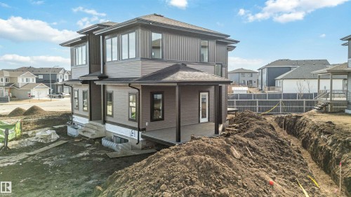The property features a contemporary exterior with multi-toned siding and a covered patio area - 33 Harley Way Nw, Spruce Grove, AB - Outdoor