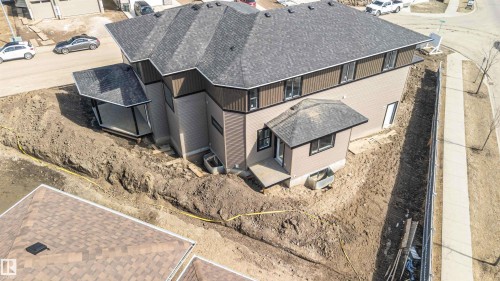 The property features a multi-level design with light brown siding and dark brown trim - 33 Harley Way Nw, Spruce Grove, AB - Outdoor