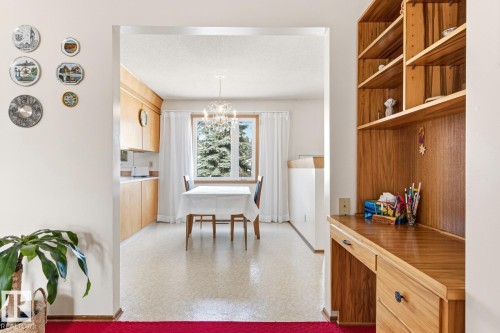 The property features a built-in wooden desk with shelving - 10716 52 Avenue, Edmonton, AB - Indoor
