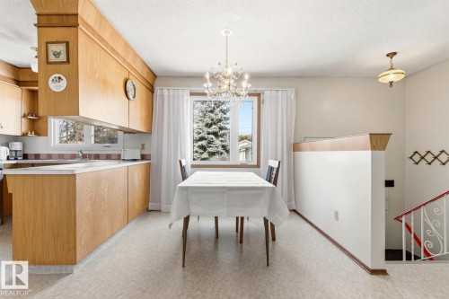 The property features an eat-in kitchen with light wood cabinetry and countertops - 10716 52 Avenue, Edmonton, AB - Indoor Photo Showing Kitchen