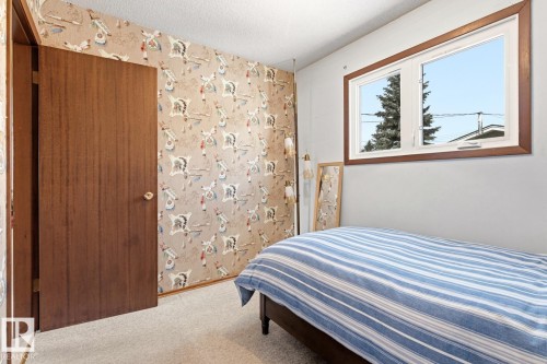 This room features a window with a wooden frame, providing natural light - 10716 52 Avenue, Edmonton, AB - Indoor Photo Showing Bedroom
