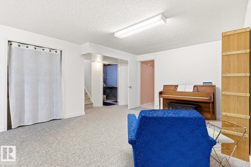 Spacious room with light-colored carpet flooring and white walls - 10716 52 Avenue, Edmonton, AB - Indoor