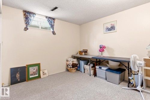 This room features light-colored walls and a textured ceiling - 10716 52 Avenue, Edmonton, AB - Indoor