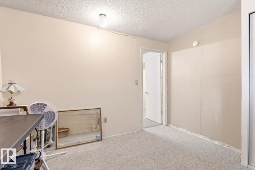 The interior features light-colored walls and a textured ceiling - 10716 52 Avenue, Edmonton, AB - Indoor