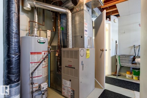 The utility area features a water heater and a furnace - 10716 52 Avenue, Edmonton, AB - Indoor Photo Showing Basement