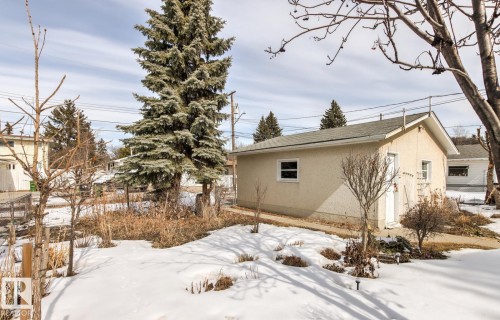 The property features a detached garage with a side door entry and a window - 10716 52 Avenue, Edmonton, AB - Outdoor