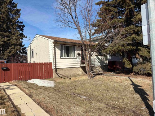 The property features light-colored siding on its exterior walls and a brown roof - 10916 151 Street, Edmonton, AB - Outdoor