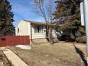The property features light-colored siding on its exterior walls and a brown roof - 10916 151 Street, Edmonton, AB  - Outdoor 