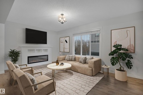 79 50 Mclaughlin Drive, Spruce Grove, AB - Indoor Photo Showing Living Room With Fireplace