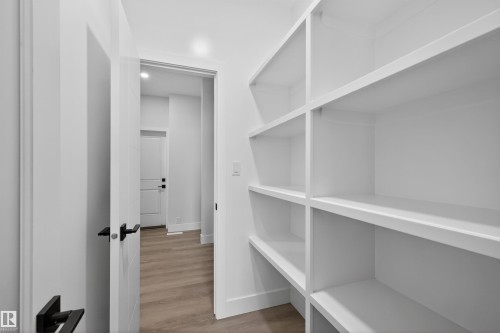 The property features extensive built-in shelving, providing generous storage solutions - 190 Elliott Wynd, Fort Saskatchewan, AB - Indoor