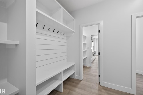 Built-in storage solutions featuring shelving, a bench, and hooks, with light-colored flooring - 190 Elliott Wynd, Fort Saskatchewan, AB - Indoor Photo Showing Other Room