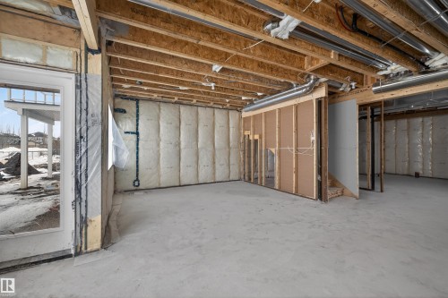 The property features an unfinished basement with exposed wooden beams and ductwork - 190 Elliott Wynd, Fort Saskatchewan, AB - Indoor Photo Showing Basement
