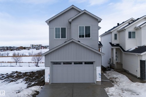 The property features a two-story exterior with light gray siding and a dark gray roof - 190 Elliott Wynd, Fort Saskatchewan, AB - Outdoor