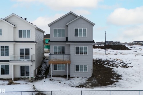 The property features a multi-story design with light gray siding and white trim around the windows - 190 Elliott Wynd, Fort Saskatchewan, AB - Outdoor With Facade