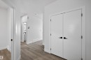 The interior features modern white doors with matte black hardware, complemented by light-colored flooring - 190 Elliott Wynd, Fort Saskatchewan, AB  - Indoor Photo Showing Other Room 