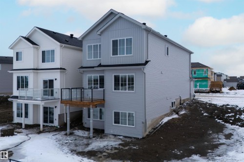 The property features a multi-level design with light grey siding and a dark roof - 190 Elliott Wynd, Fort Saskatchewan, AB - Outdoor