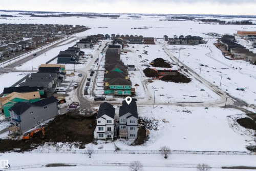 Aerial view of the property and its surrounding area, featuring paved roads and residential structures - 190 Elliott Wynd, Fort Saskatchewan, AB - Outdoor With View
