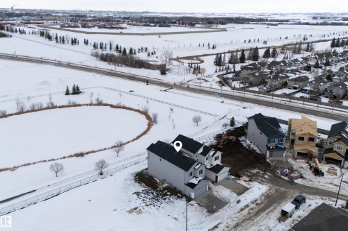 The property features a two-story design with a gray exterior and an attached garage - 190 Elliott Wynd, Fort Saskatchewan, AB - Outdoor With View