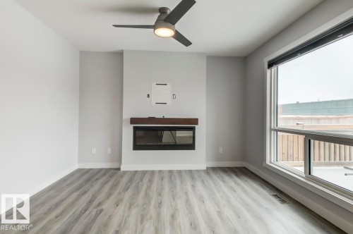 1714 169 St Sw, Edmonton, AB - Indoor Photo Showing Living Room With Fireplace