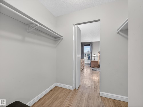 This property features light-colored walls and wood-look flooring, creating a bright and inviting atmosphere - 165 2703 79 Street, Edmonton, AB - Indoor With Storage