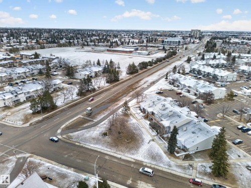 Aerial view showcasing the property's location within a developed neighborhood, featuring streets, buildings, and trees - 165 2703 79 Street, Edmonton, AB - Outdoor With View