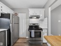 Kitchen with white cabinetry, stainless steel appliances, and wood-look flooring - 165 2703 79 Street, Edmonton, AB  - Indoor Photo Showing Kitchen 