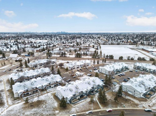 Aerial view of the property showing several residential buildings with snow-covered roofs and surrounding grounds - 165 2703 79 Street, Edmonton, AB - Outdoor With View