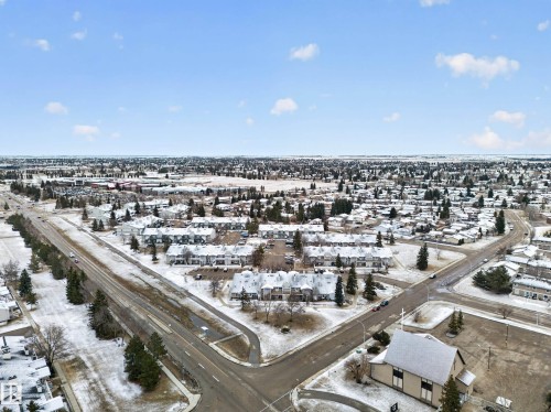 Aerial view of the surrounding neighbourhood featuring residential properties with snow-covered roofs and mature trees - 165 2703 79 Street, Edmonton, AB - Outdoor With View