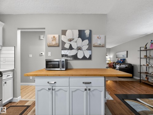 The kitchen features white cabinetry and a light wood countertop - 165 2703 79 Street, Edmonton, AB - Indoor Photo Showing Kitchen